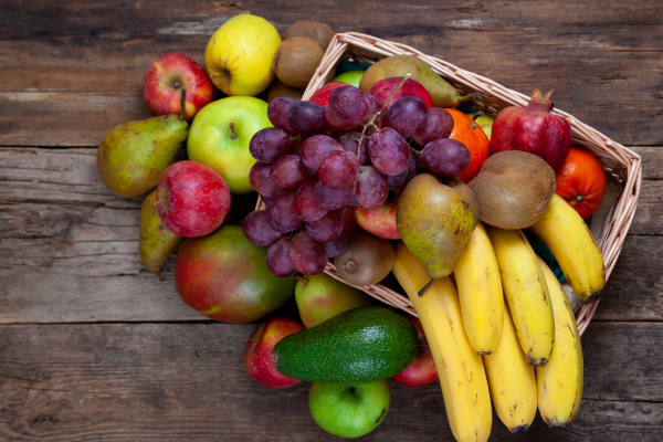 Fruit Basket, Assortment of Fruits from Top View. Nutrient-Rich Foods. Bananas, Apples, Grapes, and Avocados. Mangoes and Pears, Fruits That Boost Fertility.