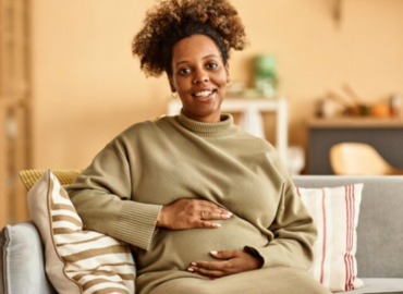 A Black expectant mother at her home after success of IVF at age 40 