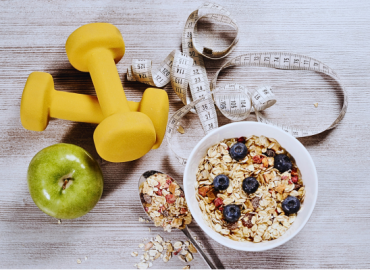 Healthy food and lifestyle concept featuring exercise weights to support a healthy weight for fertility.