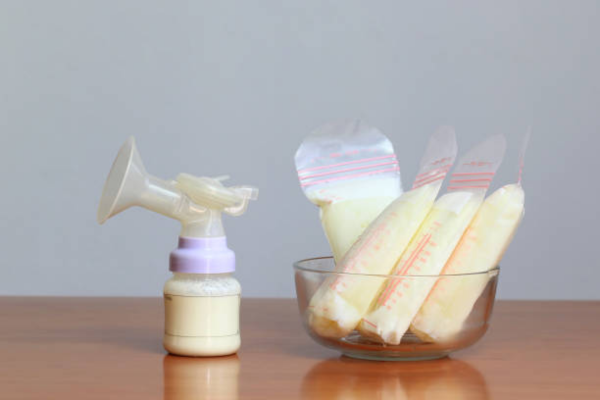 Breast milk storage bottles arranged neatly, showing; How to Store Breast Milk