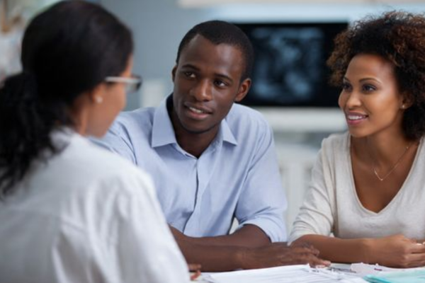 A couple consulting with a reproductive endocrinologist about secondary infertility treatment options.